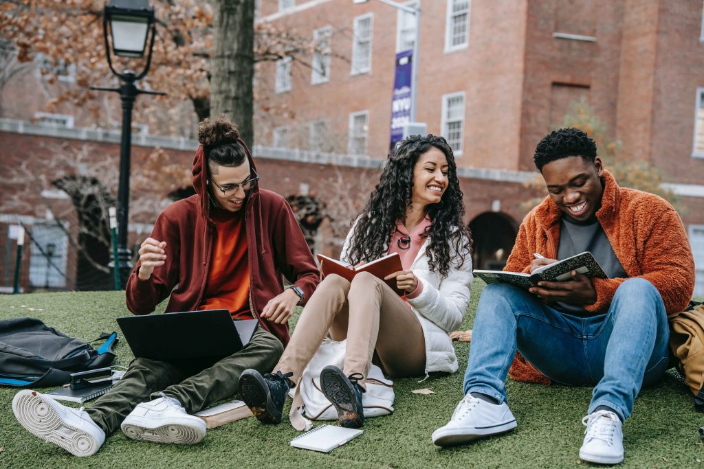 Students after university sitting on park